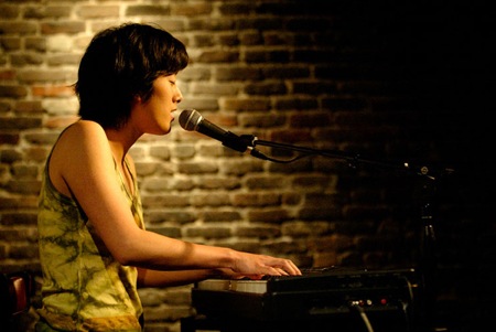 Photo of Vienna Teng playing piano