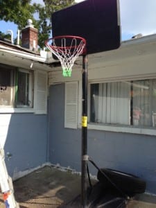 David Esrati hangs basketball nets as part of his election campaign.