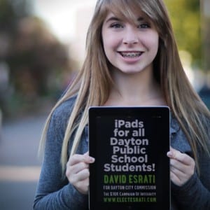 Photo of Maya White, holding an iPad, promoting the campaign of David Esrati for Dayton City Commission and iPads for Dayton Public Schools students.