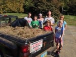 The bed of a pickup truck was filled with dirt and weeds from the court