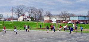Kids playing basketball at DeSoto Bass basketball courts- with an Esrati supplied free green net