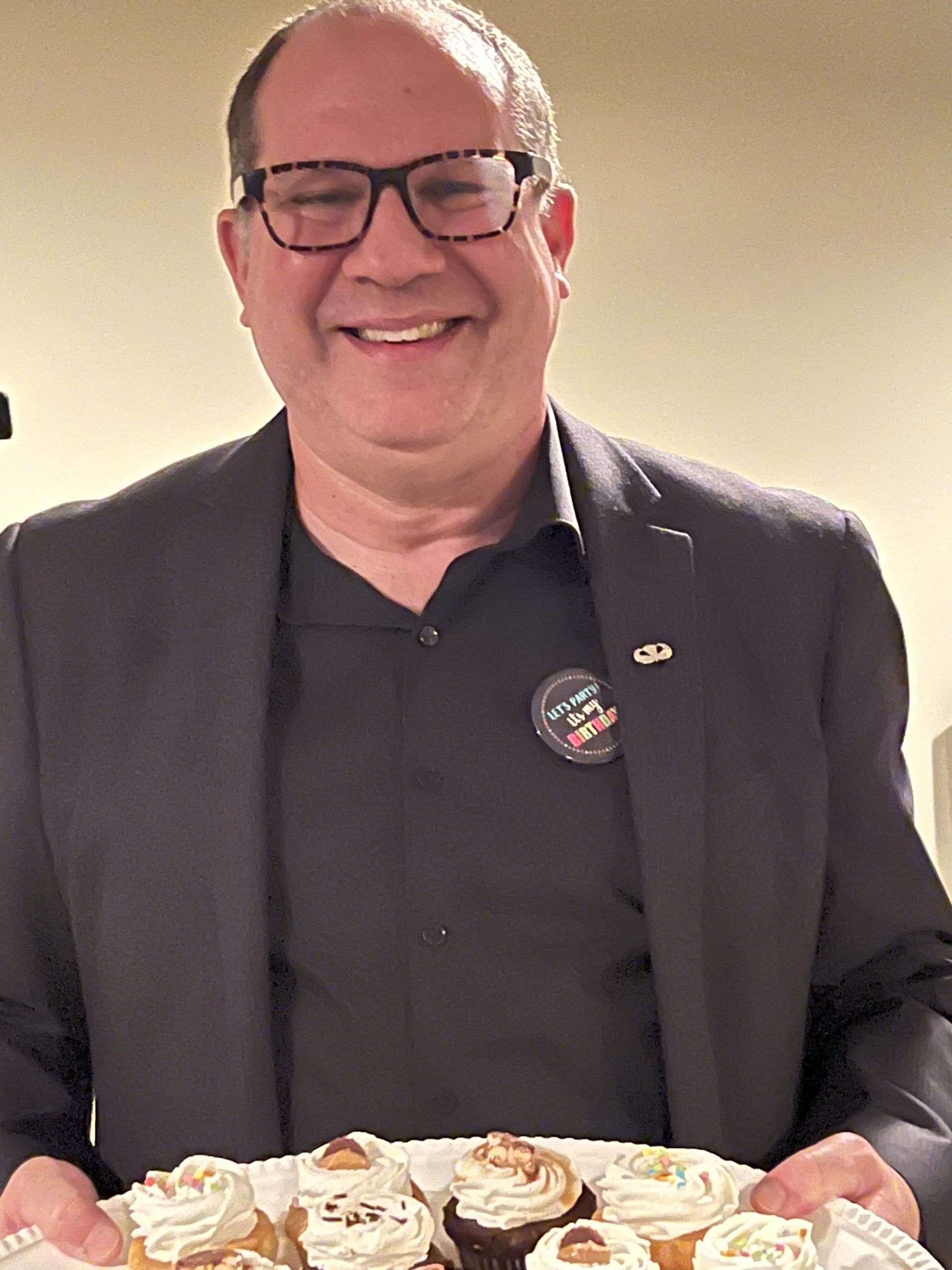 David Esrati serving cupcakes David Esrati serving Twist cupcakery cupcakes at his birthday fundraiser